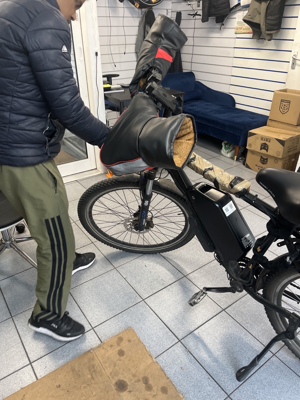 A mechanic working on an electric bike inside Bethnal Green Cycles.