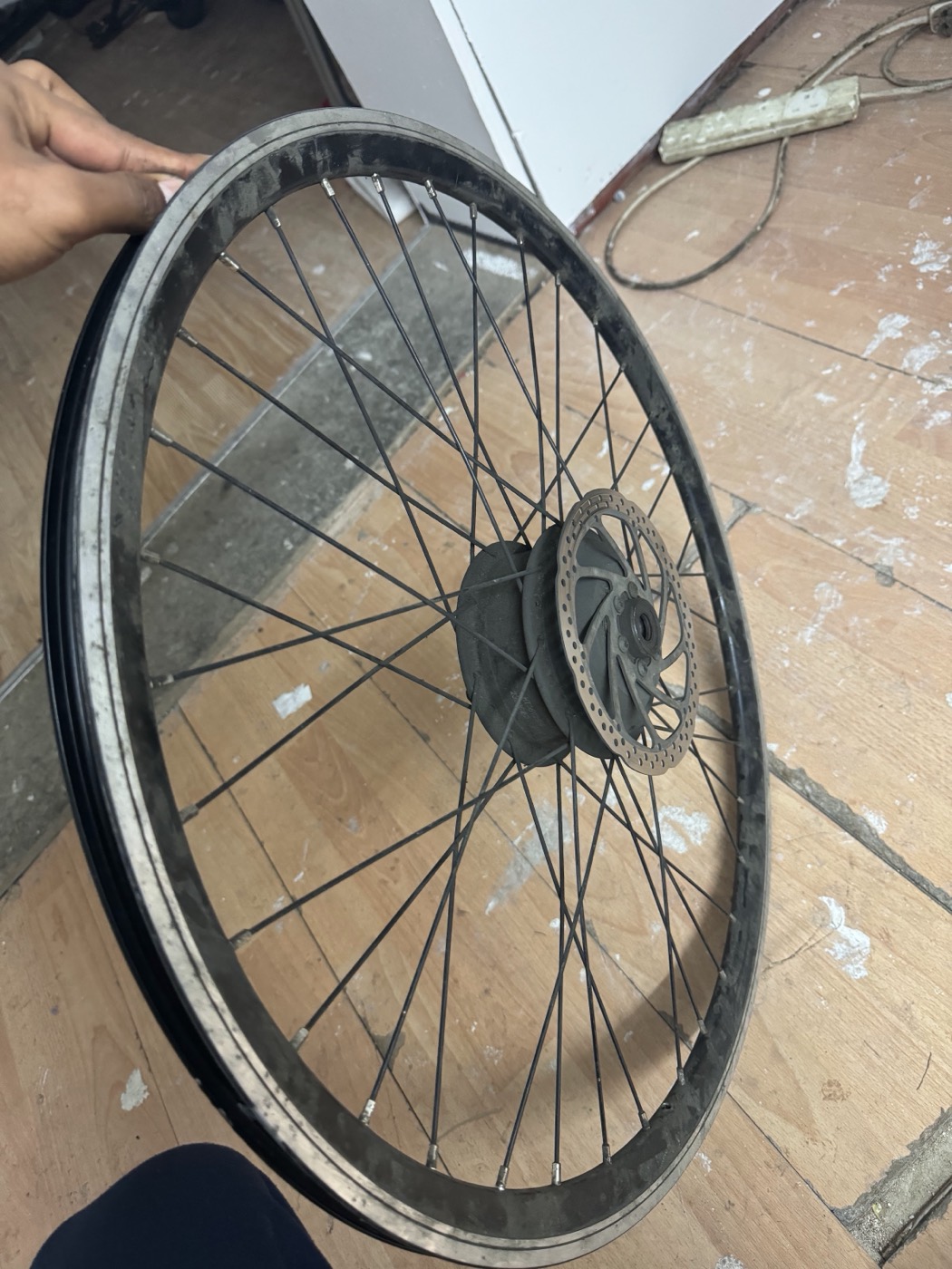 A bicycle wheel being checked and trued by hand at Bethnal Green Cycles.